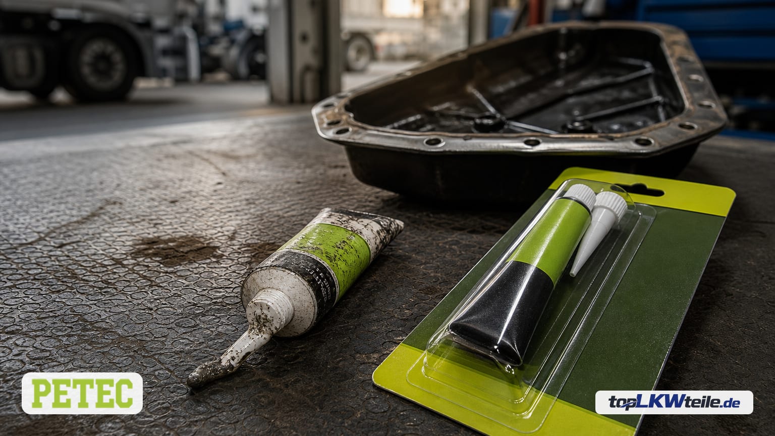 New PETEC Dichtung, Automatikgetriebe in green blister next to a used tube on a workshop mat; transmission oil pan softly blurred in the background.